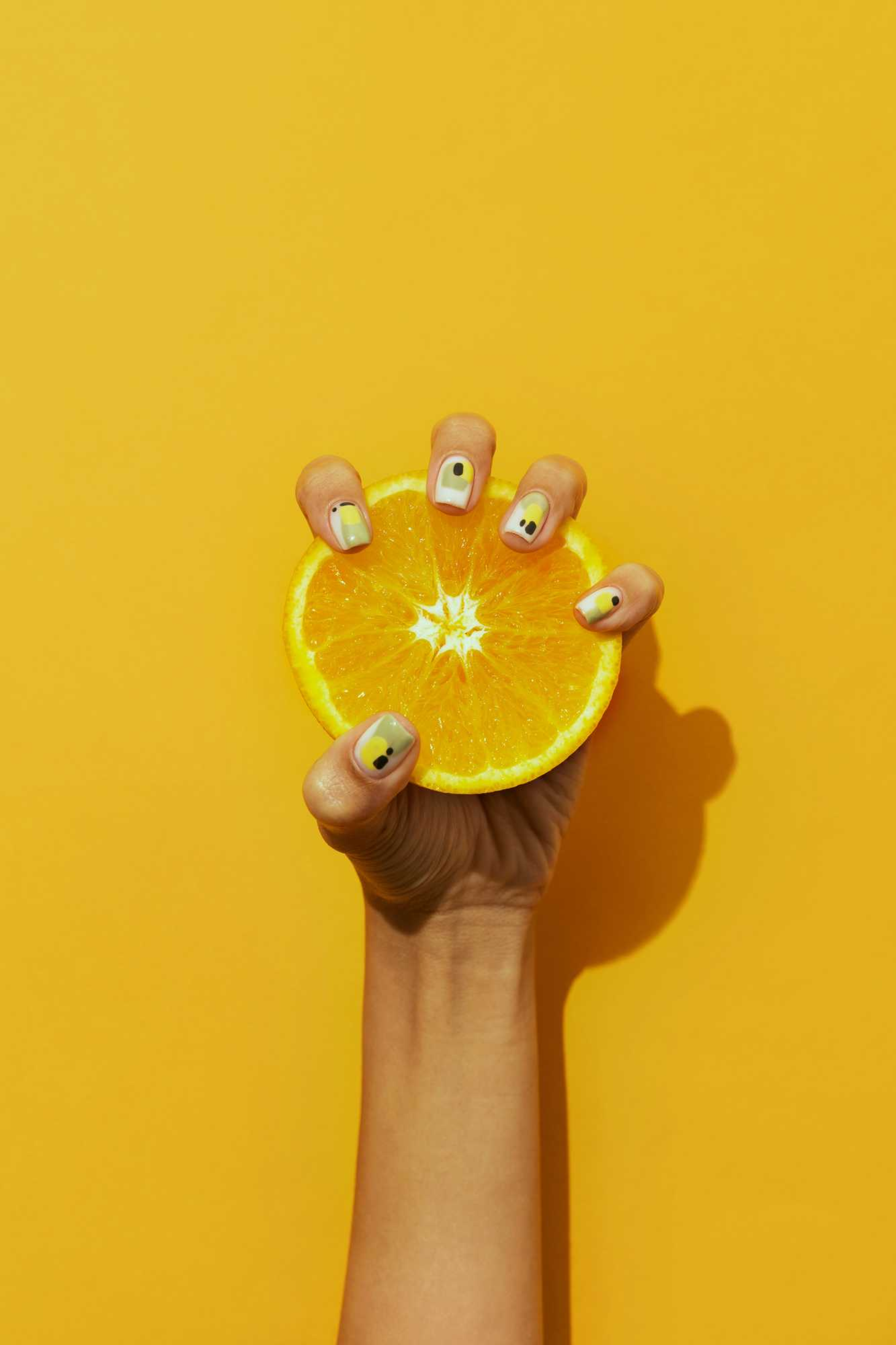 woman-showing-her-nail-art-fingernails-with-citrus.png
